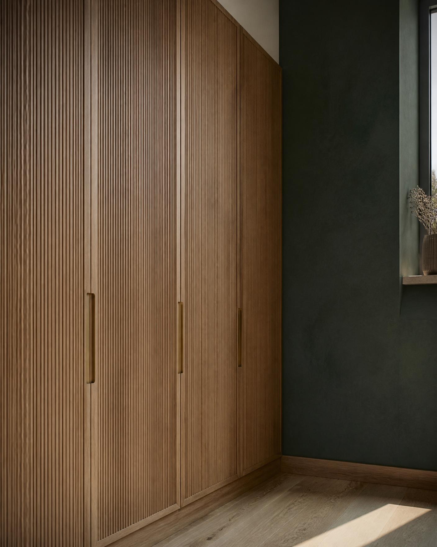 Bespoke fluted oak joinery against deep green Venetian plaster